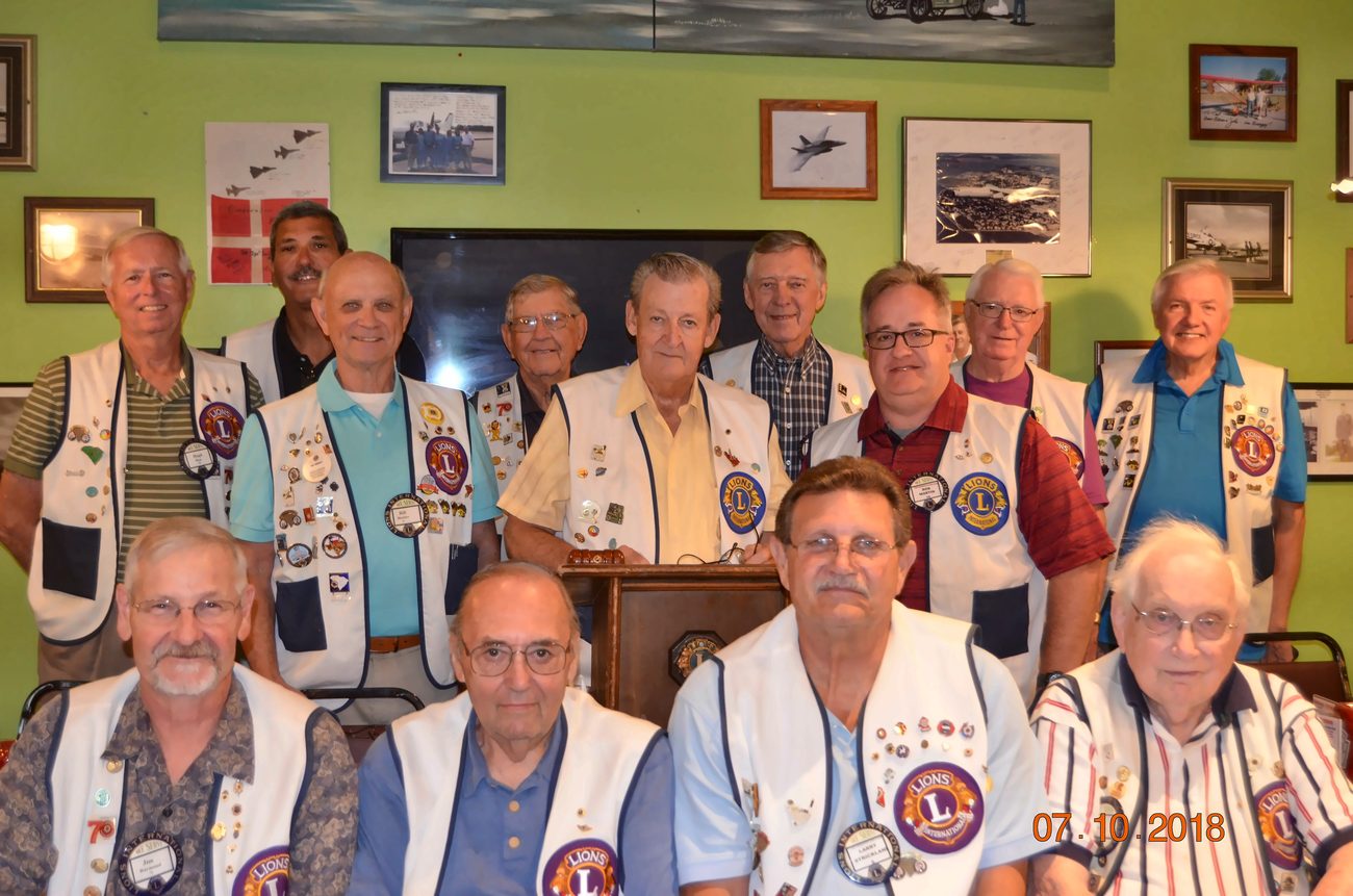 A large group of Lexington Lions Club members in white vests posing together at a 2018 club meeting.