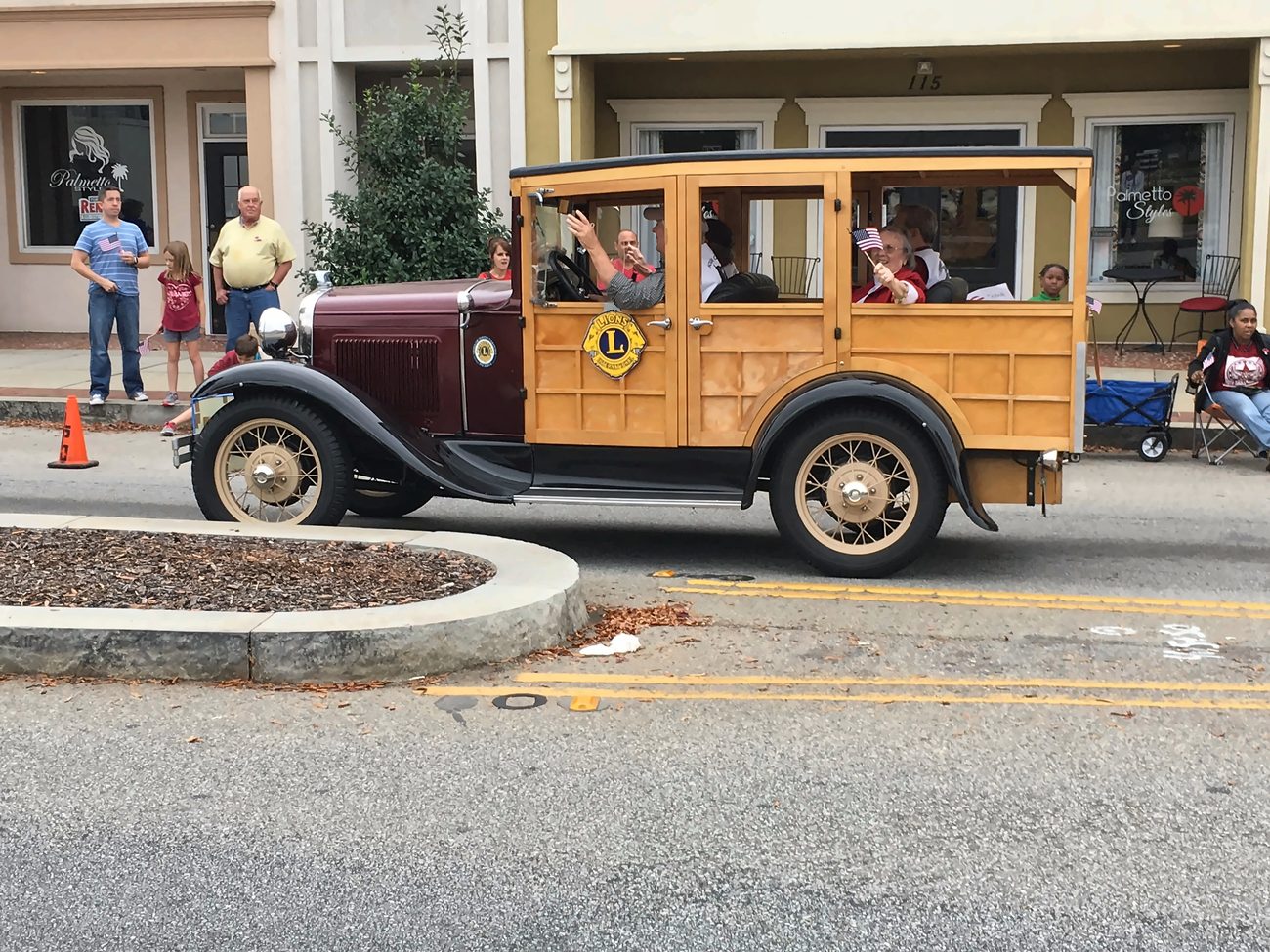 An antique Ford Model A woody wagon carrying Lexington Lions Club members in a local parade.