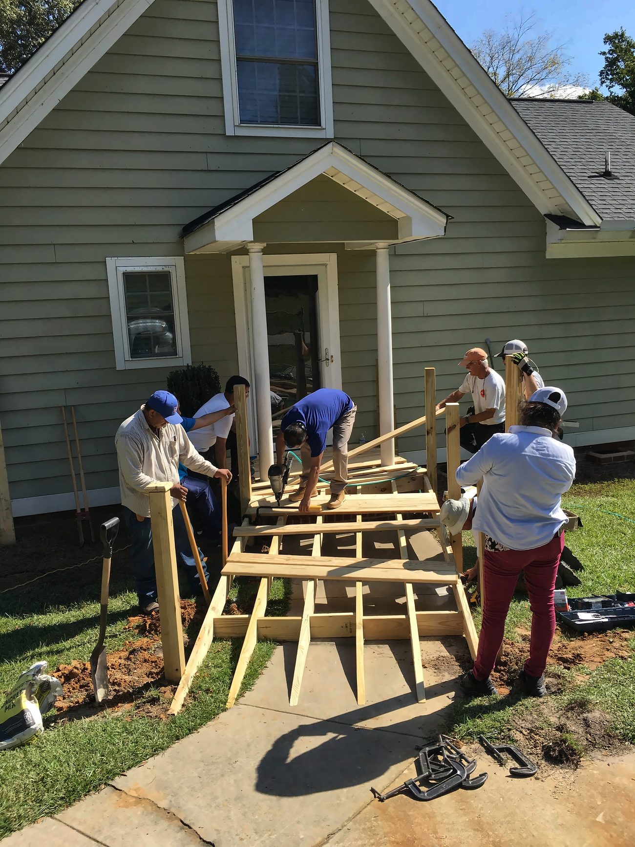 Lexington Lions Club volunteers building a wooden wheelchair ramp at a member of the community's home.